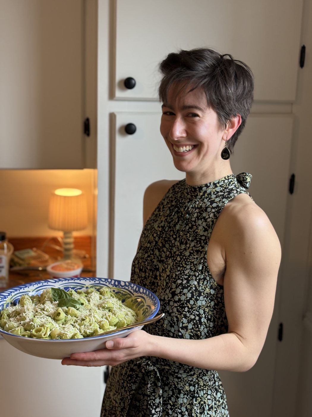 Becca holding a bowl of pasta she made